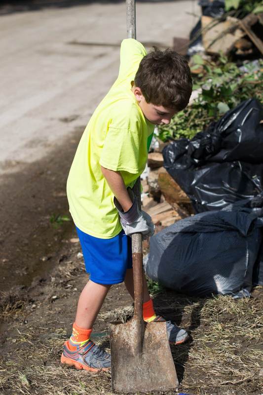 A child bagging yard debris.