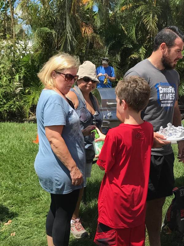 Volunteers handing supplies to a child.
