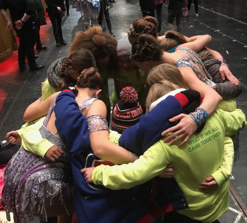 A group hug among volunteers.