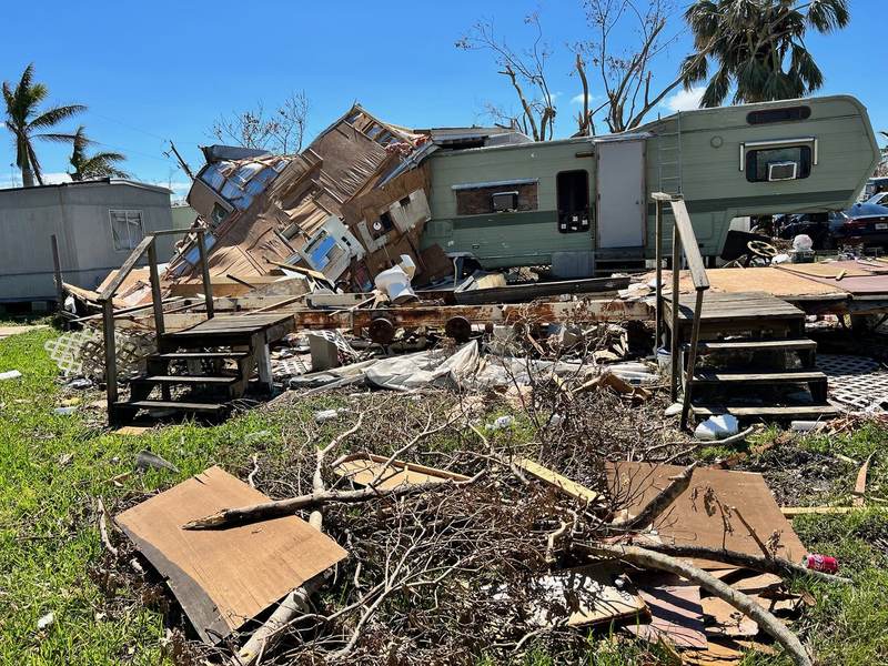 A collapsed home and scattered debris.
