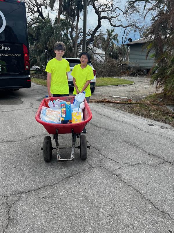 Volunteers pulling a wagon of supplies.