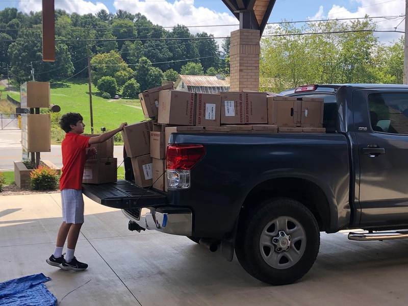 A pickup truck loaded with supply boxes.