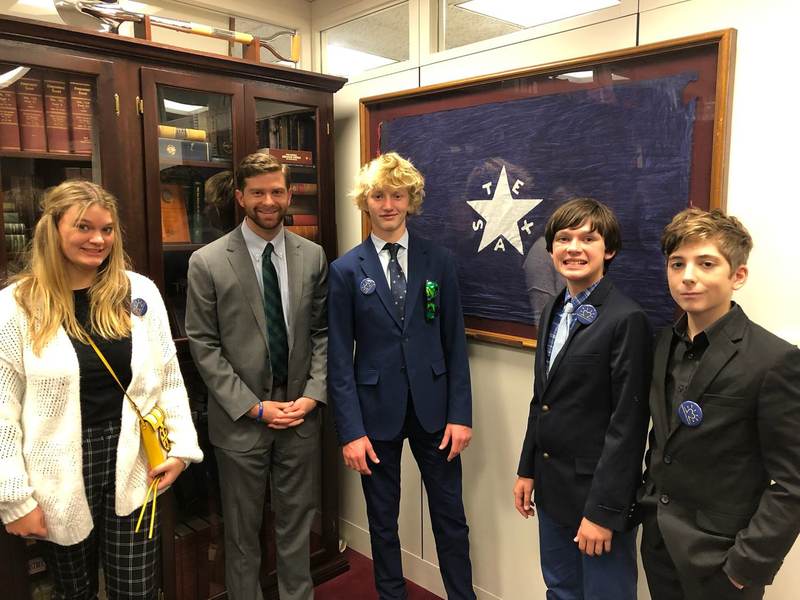 Students with adults in a congressional office.