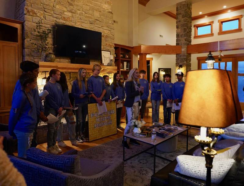 See Us Now members presenting in a living room.