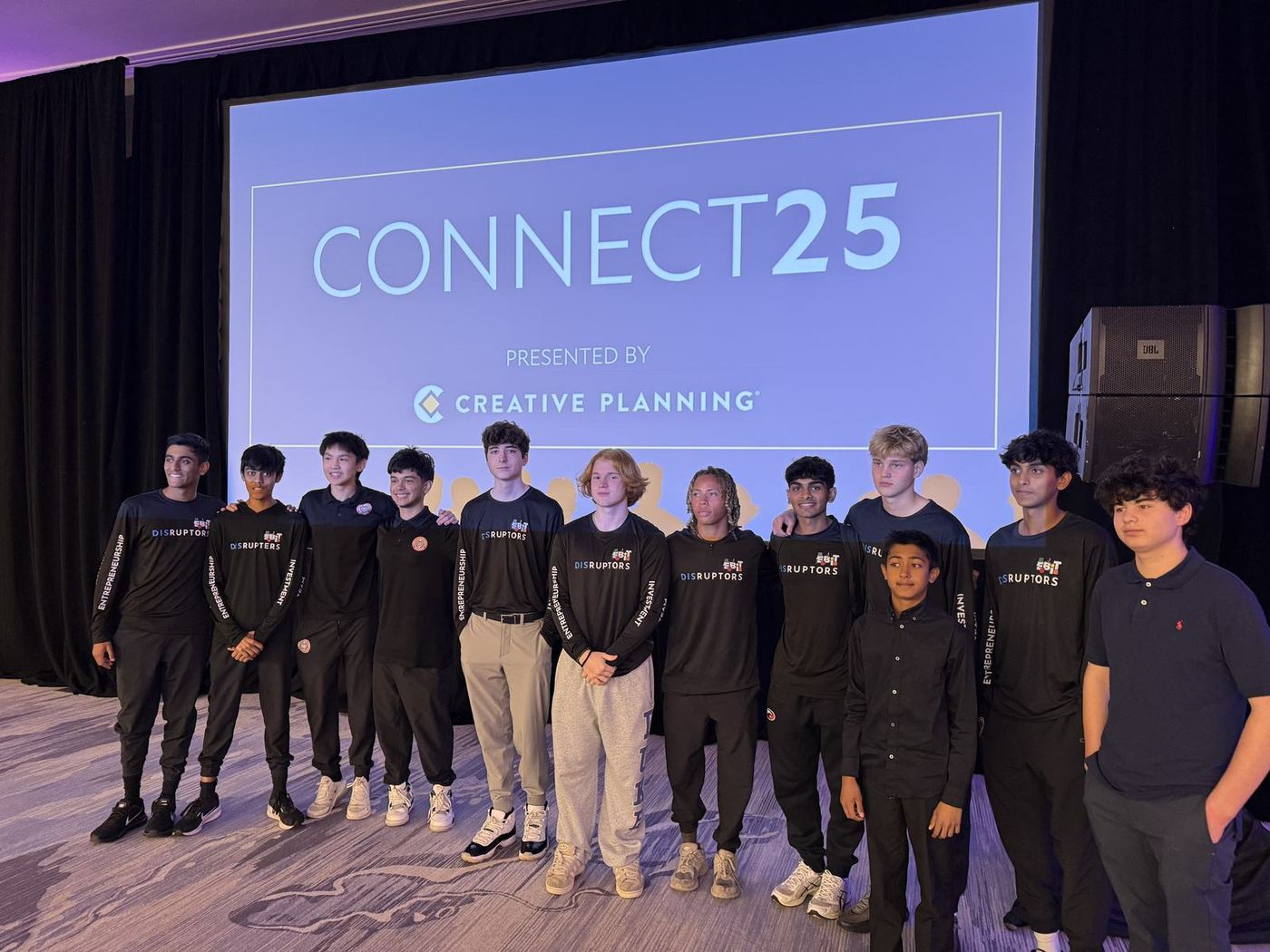 EBIT group in front of a Connect 25 screen.
