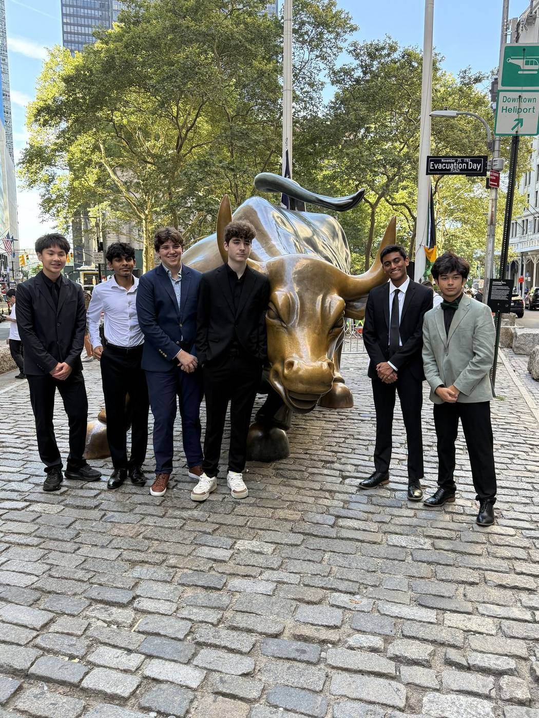 EBIT group beside the Charging Bull in New York, 2026.