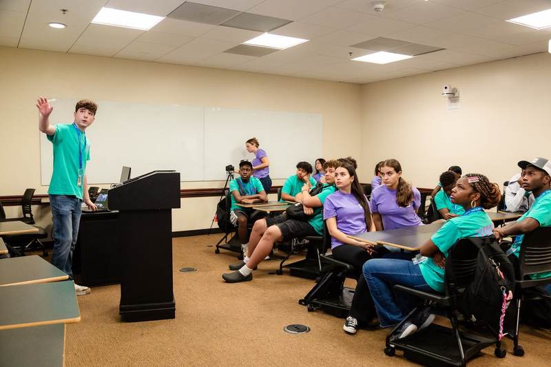 A student speaking from the front of an EBIT session.